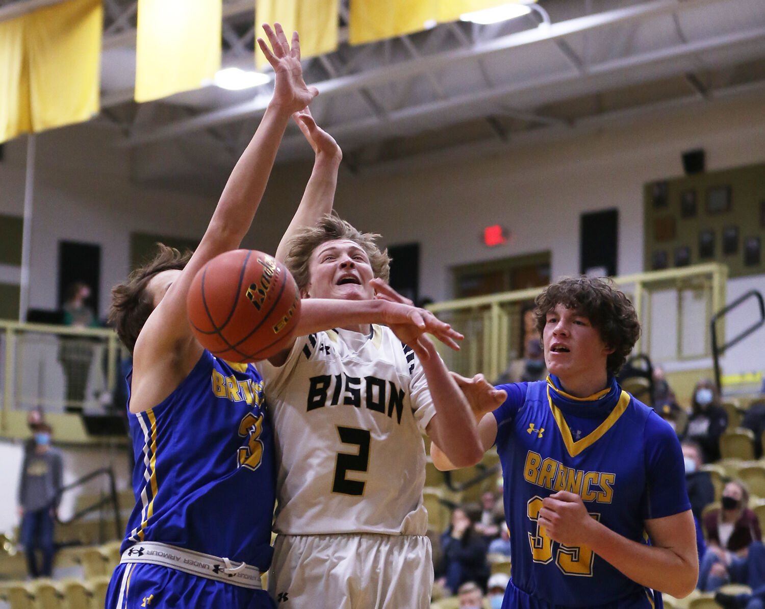 Coy Johnson pushes through Sheridan defenders Zack Koltiska and Sam Lecholat